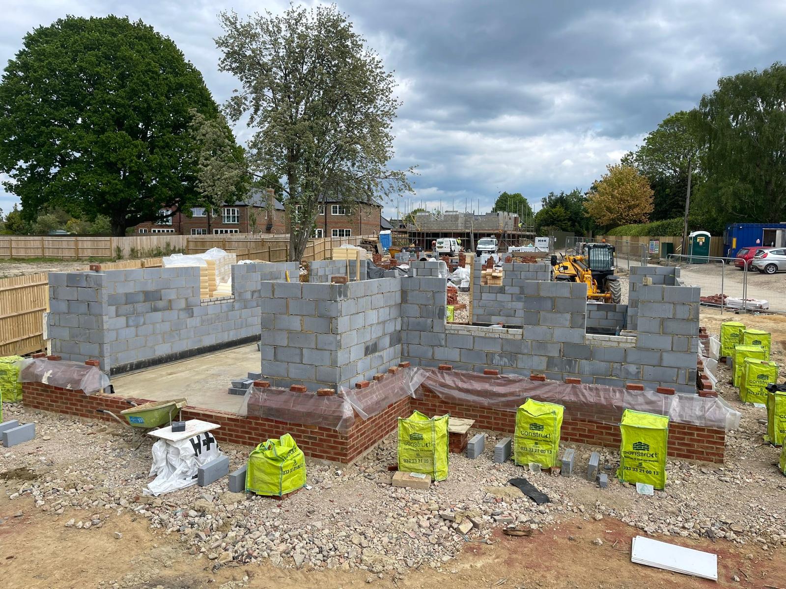Detached new-build blockwork walls climbing out of the ground