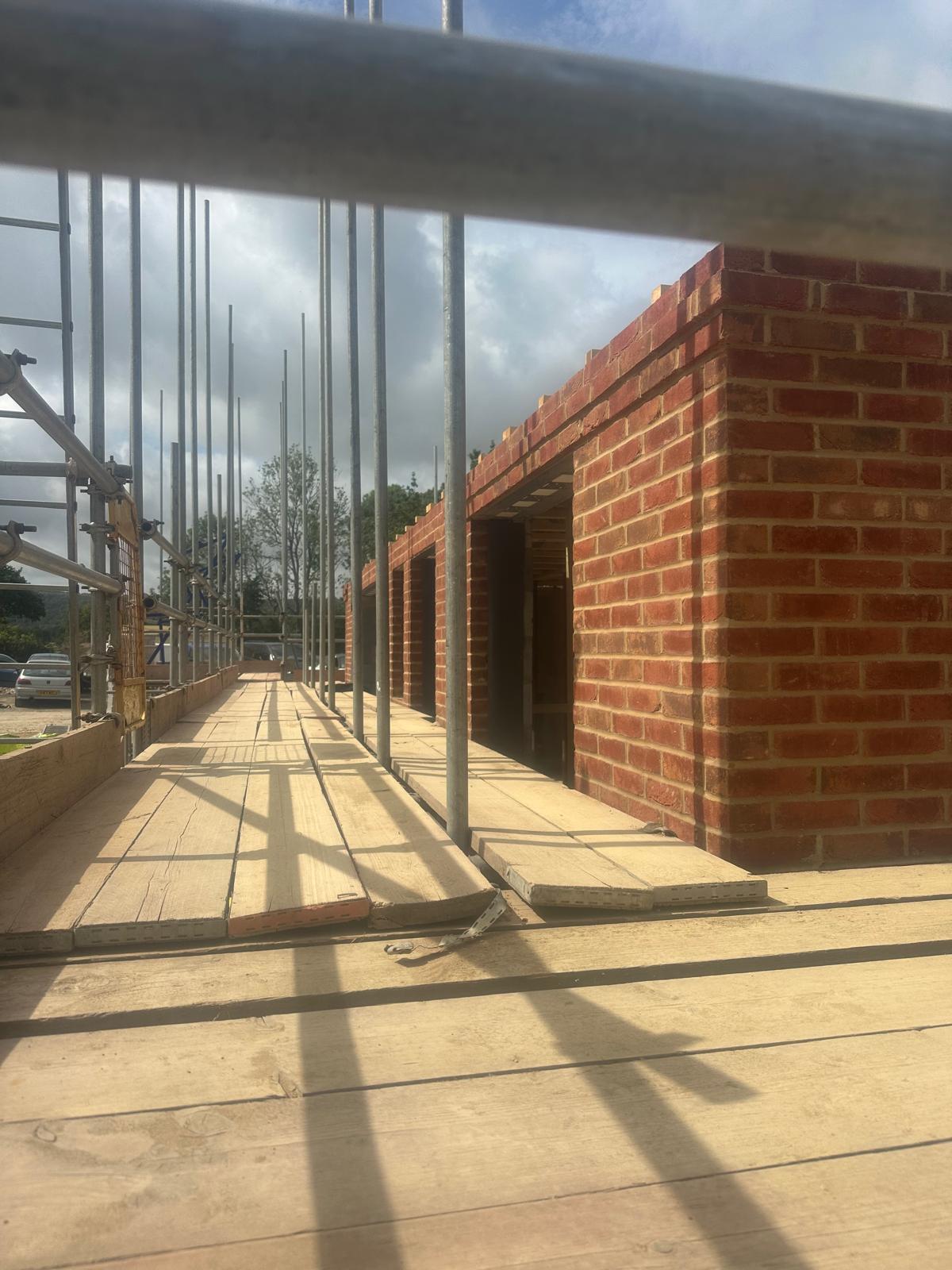 Crisp corbelled brick detail on a new-build elevation