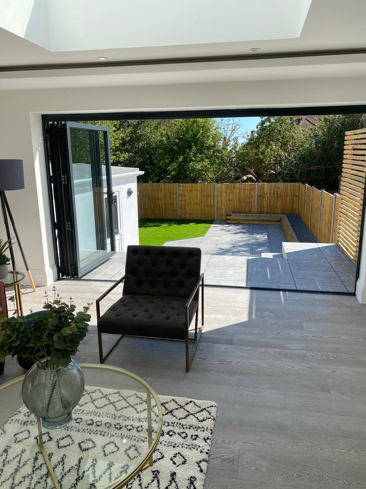 Finished extension with bifold doors opening onto a porcelain patio
