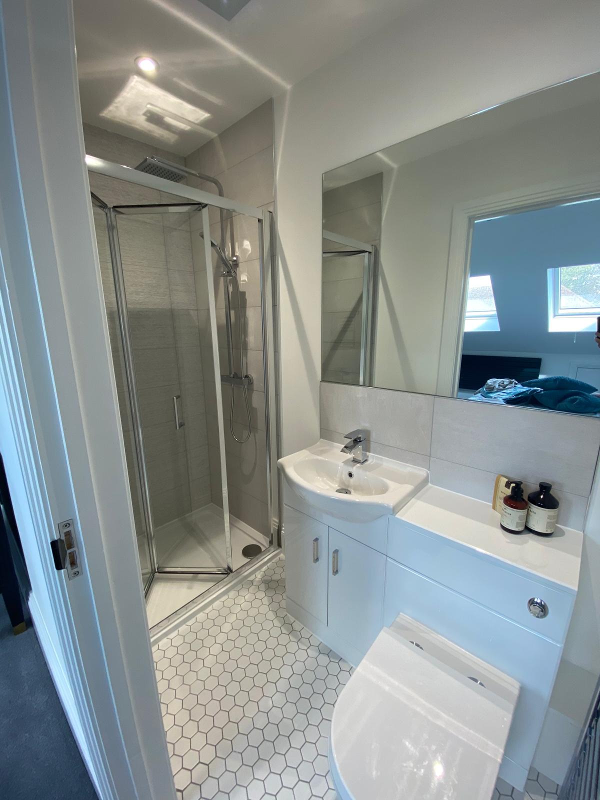 New loft en-suite shower room with tiled floor and vanity unit