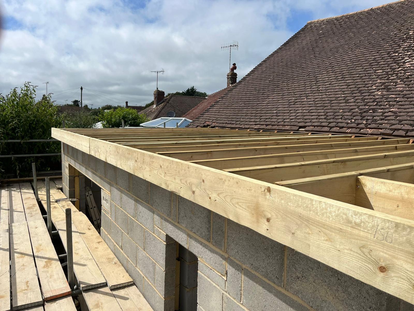 Timber joists set across the blockwork extension