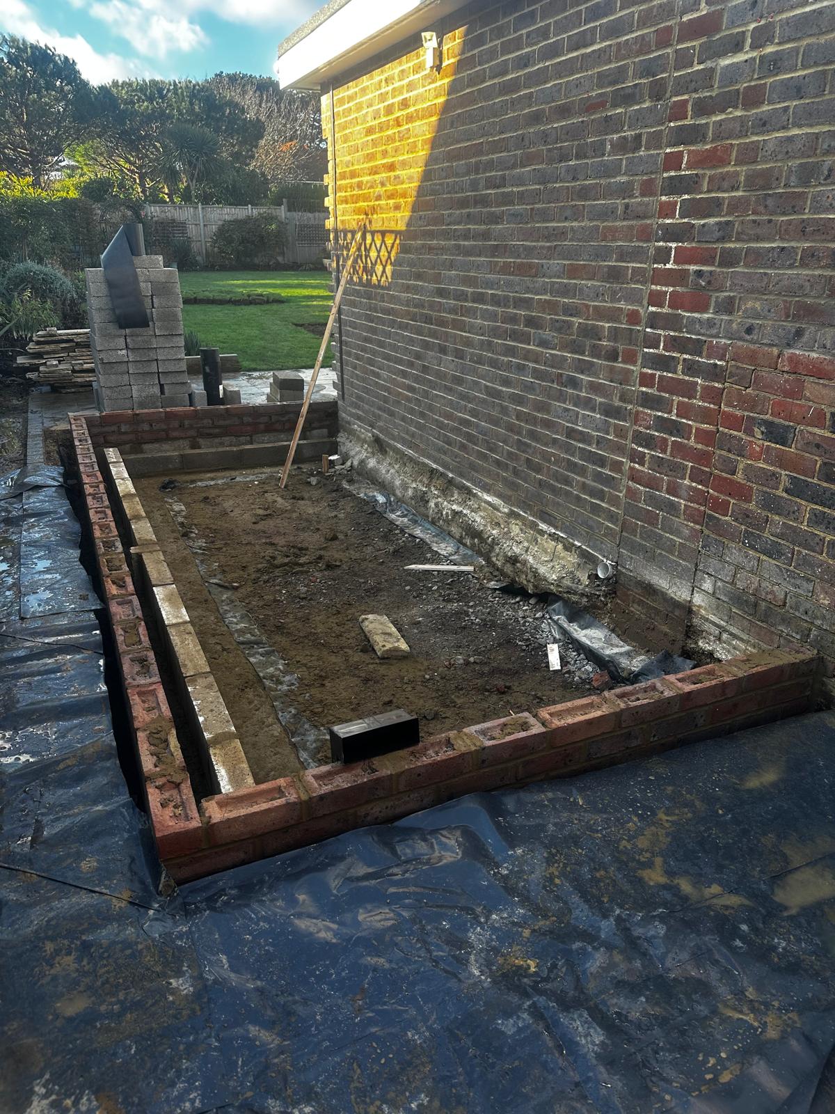 Brick footings and DPC on outbuilding