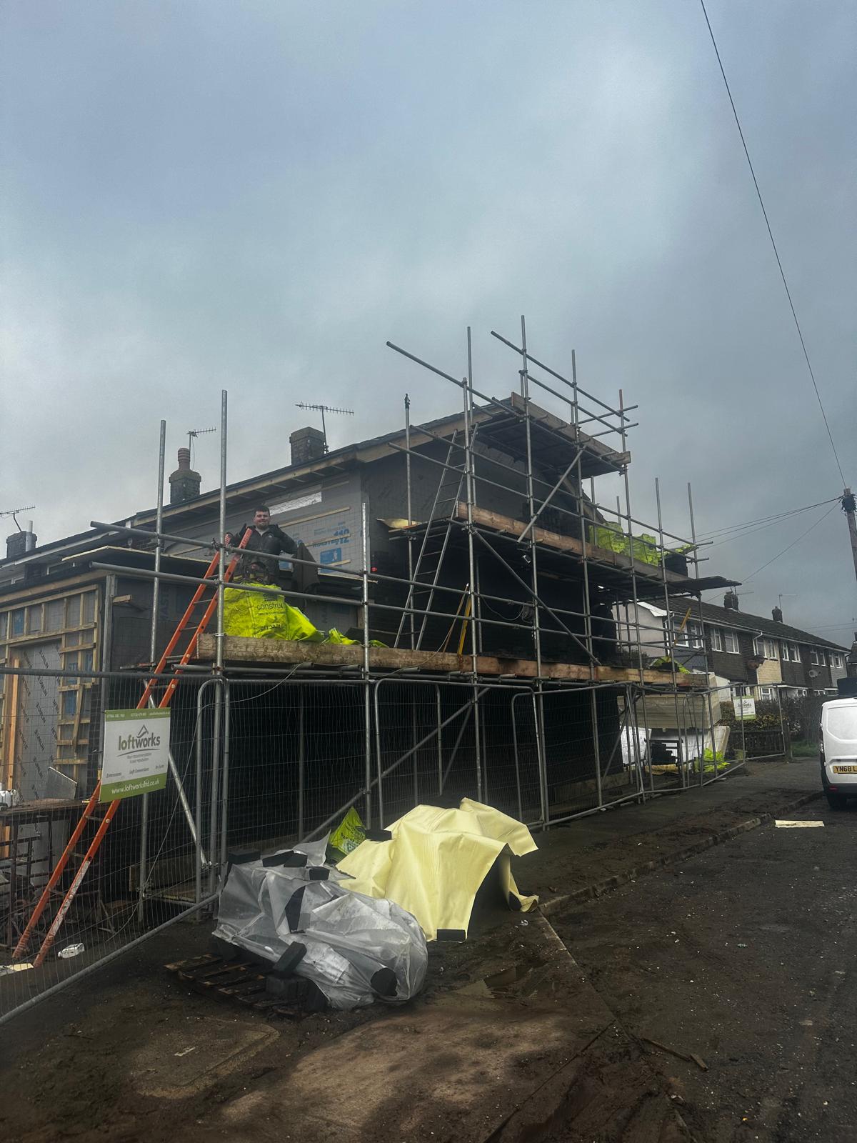 Scaffolded upper-floor extension in progress