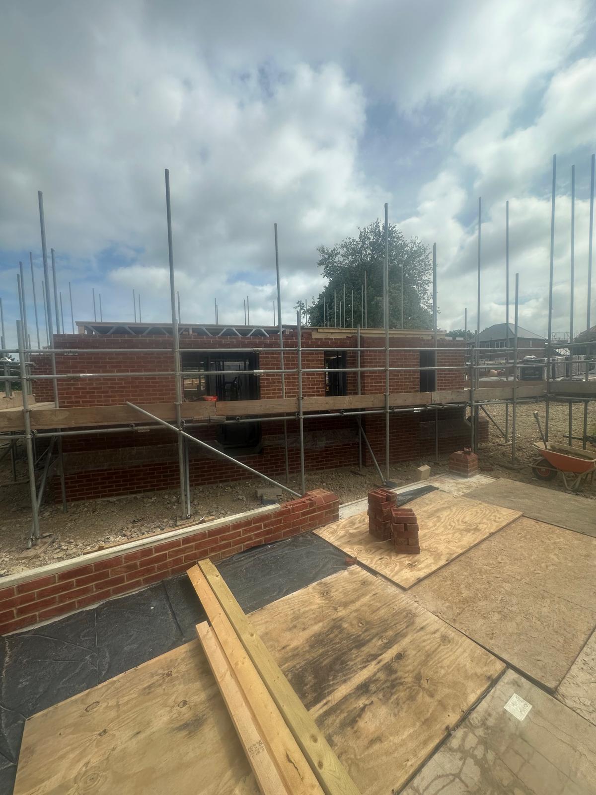 Roof trusses going on over completed brickwork