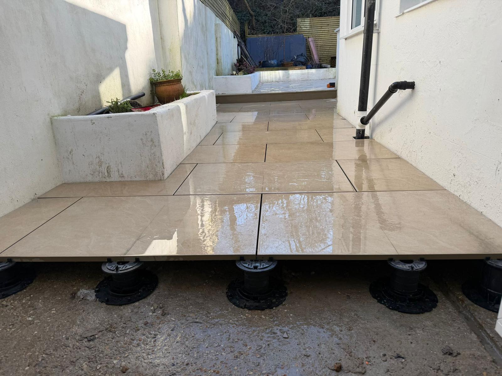 Raised porcelain patio on adjustable pedestals