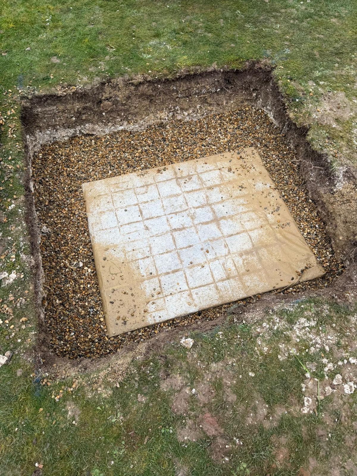 Concrete pad foundation in garden