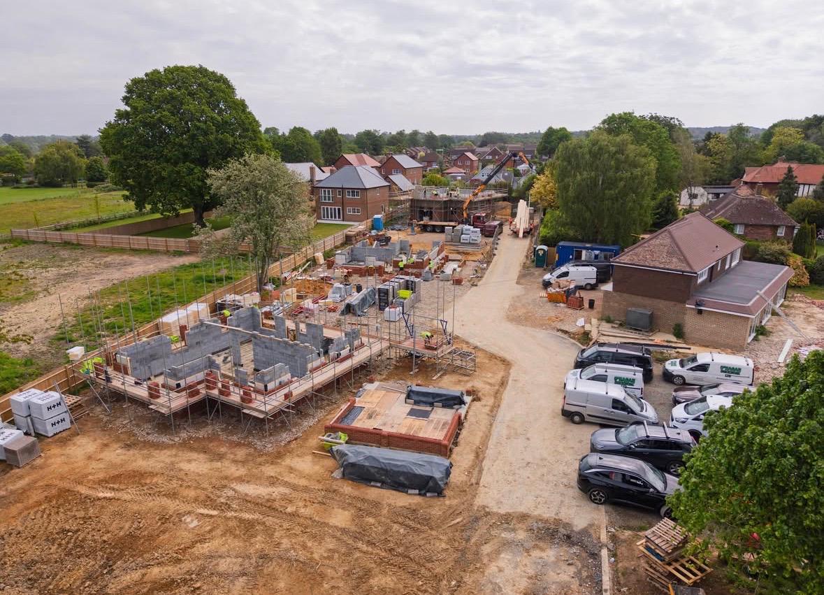 Aerial view of a multi-plot new-build site at first-lift stage
