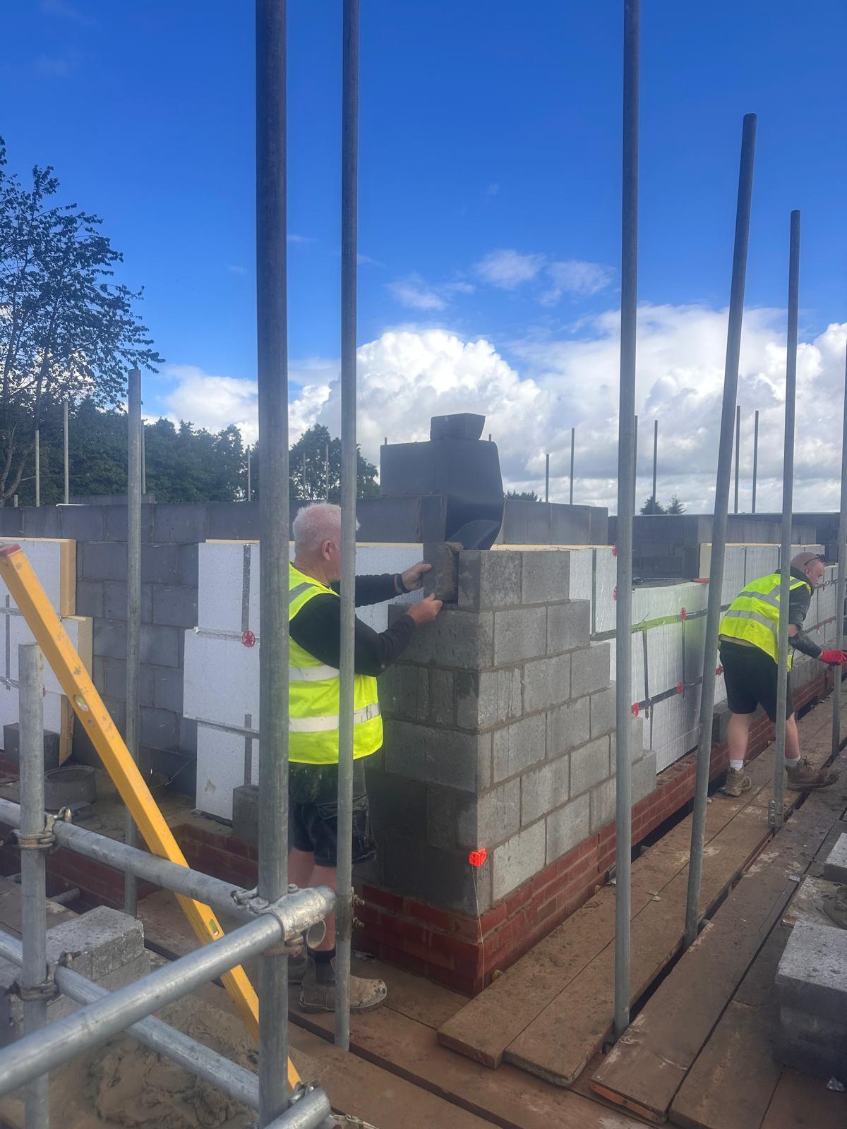 Bricklayer building the chimney pier on a new-build