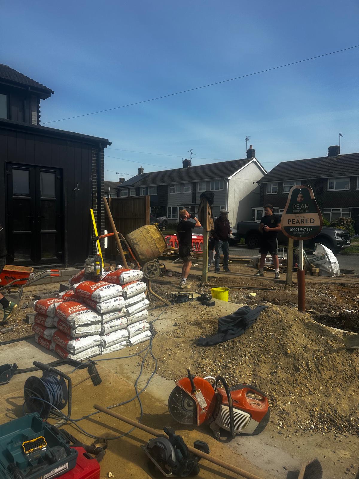 Front driveway dig with mixer and materials